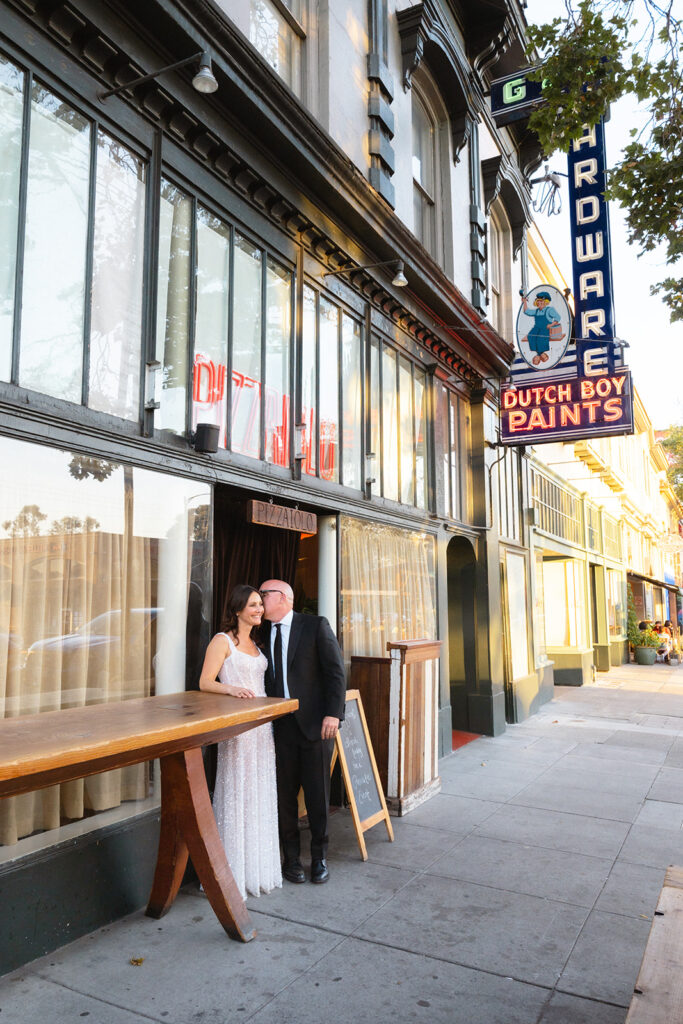 Bride and grooms wedding portraits outside of Pizzaiolo in Oakland, California