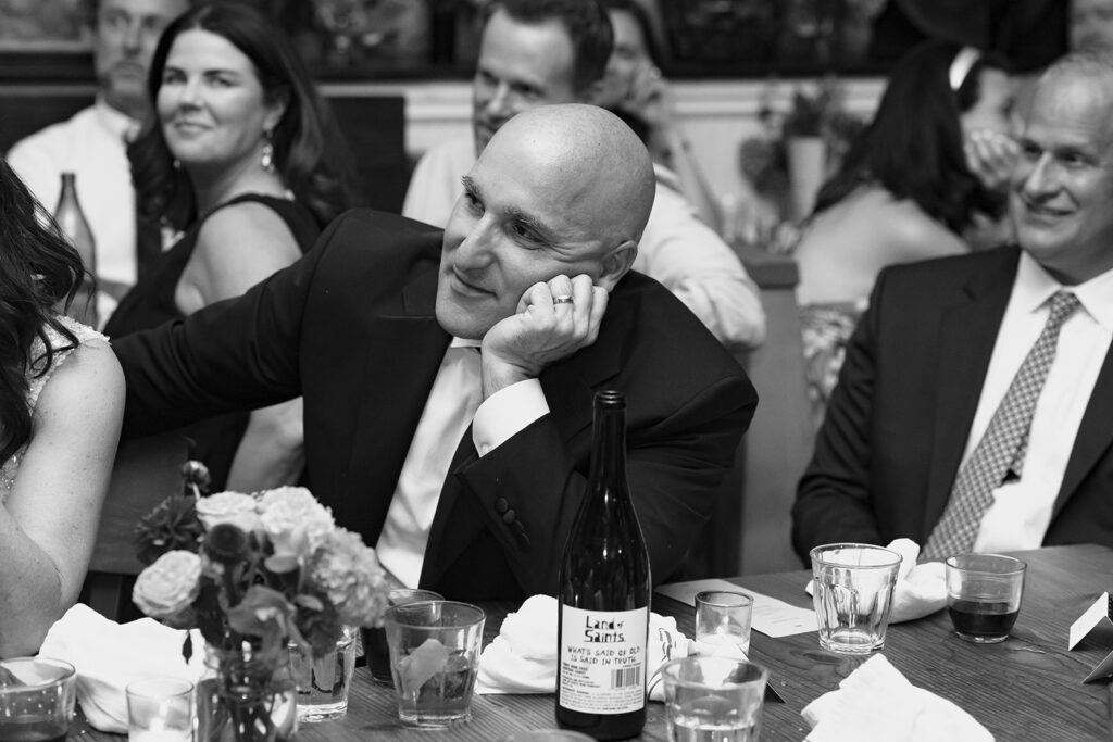 Groom listening to wedding speeches