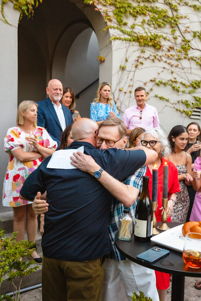 Groom hugging a guest after they gave a speech