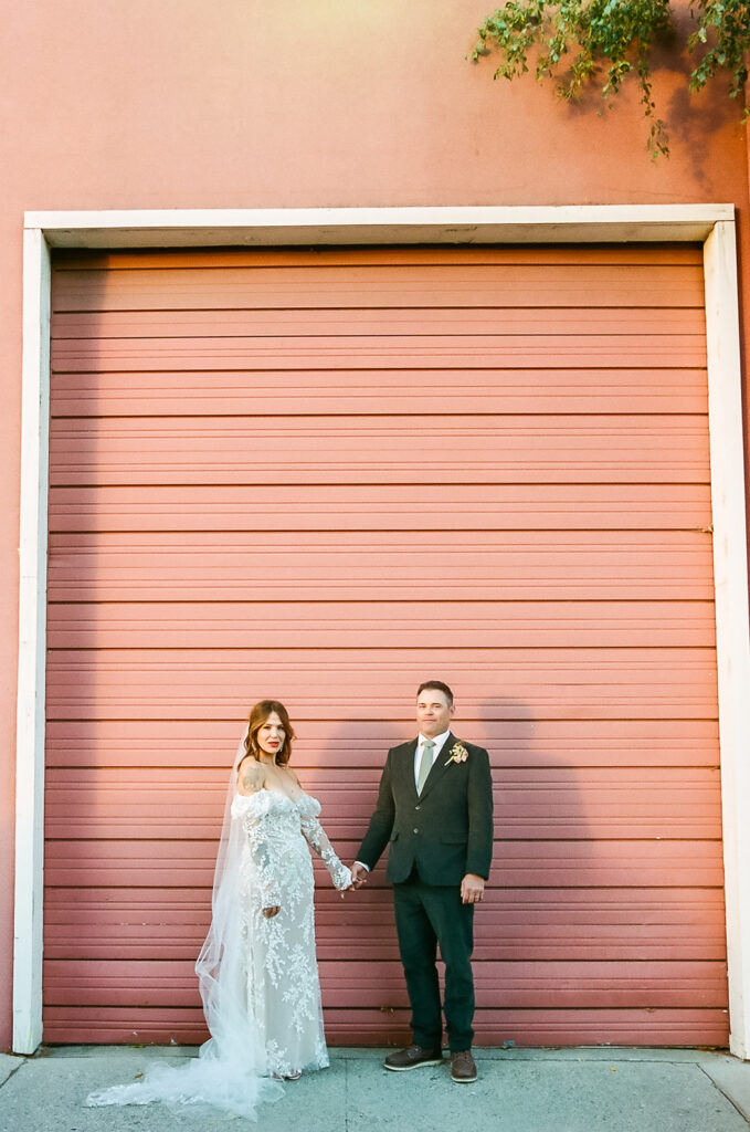 Bride and groom holding hands during portraits in Nevada City California