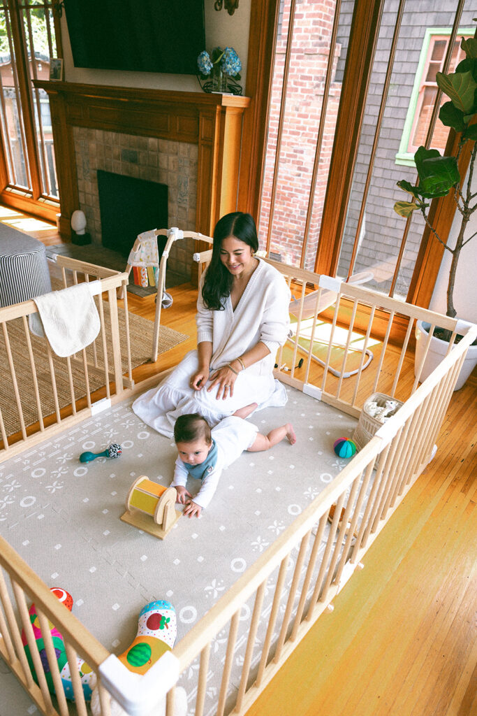Mother playing with her baby on the floor during their at-home family photos in Oakland, California.