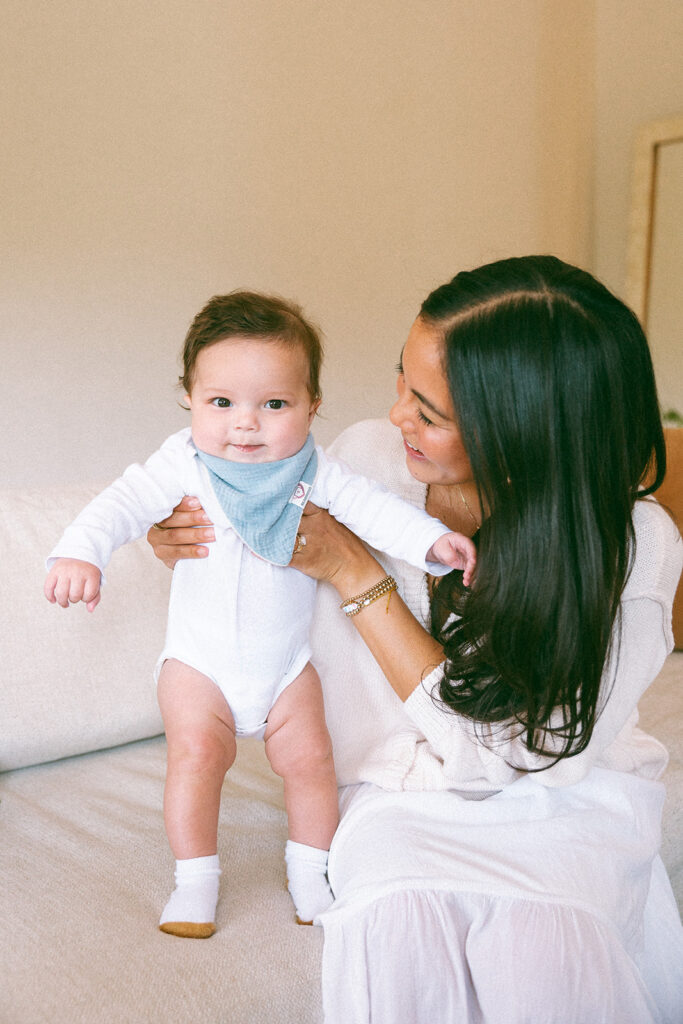 Mother holding her small baby during their at-home family photos. 