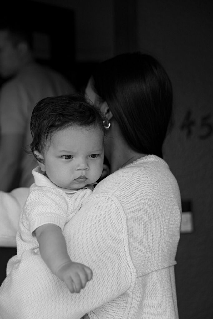 Black and white photo of a mother holding her baby. 