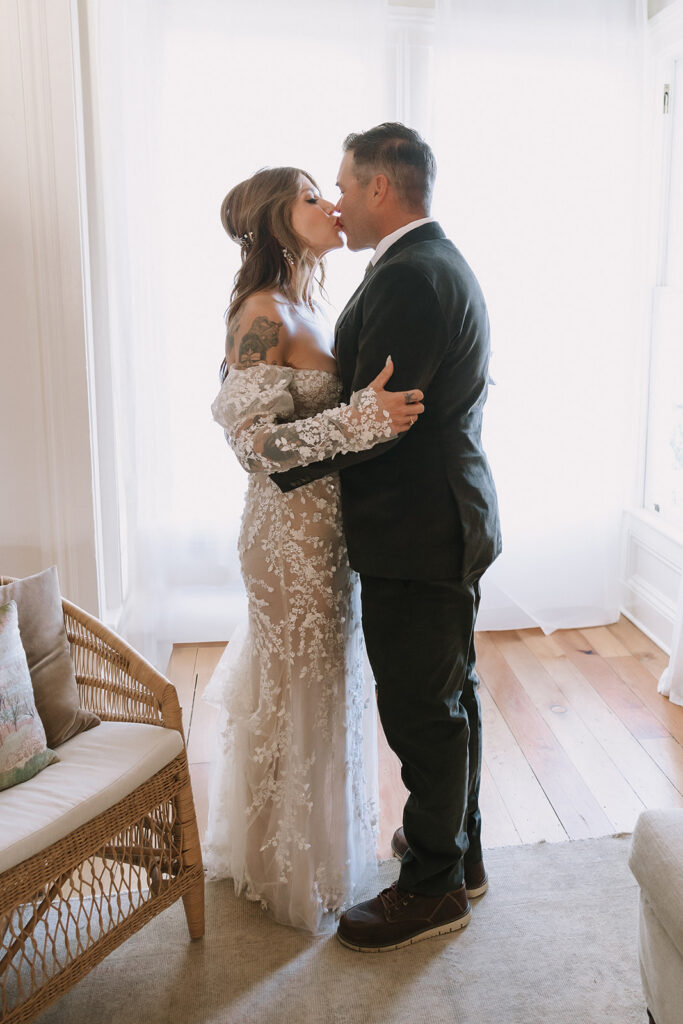 Bride and groom kissing during their first look at The Parsonage 1865 during Miners Foundry wedding in Nevada City, California.