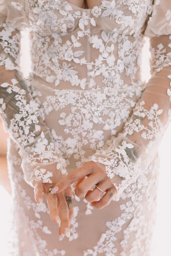 Close up of the details of a brides dress and jewelry. 