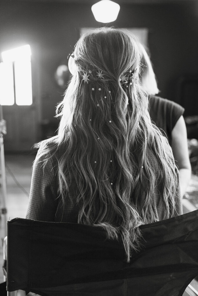 Close up of bride’s hair styling with pearl and star accessories during getting ready for Miners Foundry wedding in Nevada City, California.
