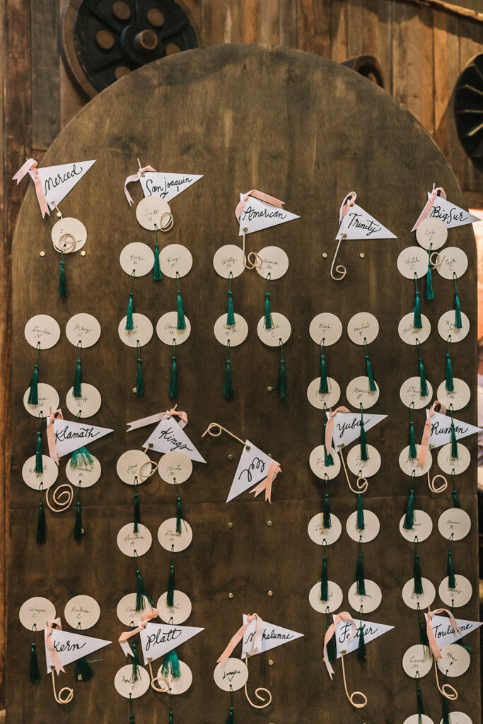 Wedding seating chart with handwritten names and tassel details at Miners Foundry wedding in Nevada City, California.