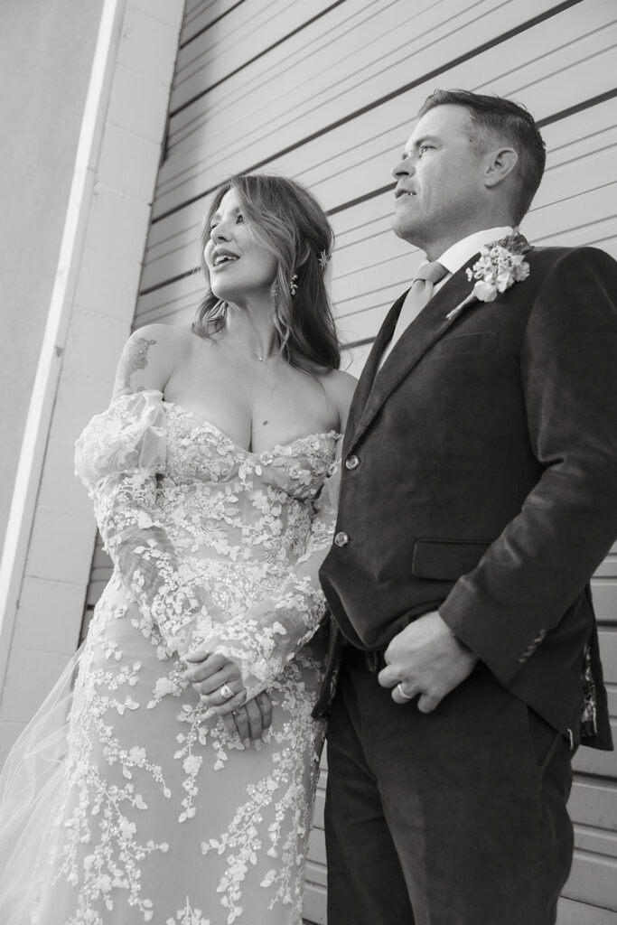 Black and white portrait of bride and groom standing together during golden hour at Miners Foundry wedding in Nevada City, California.