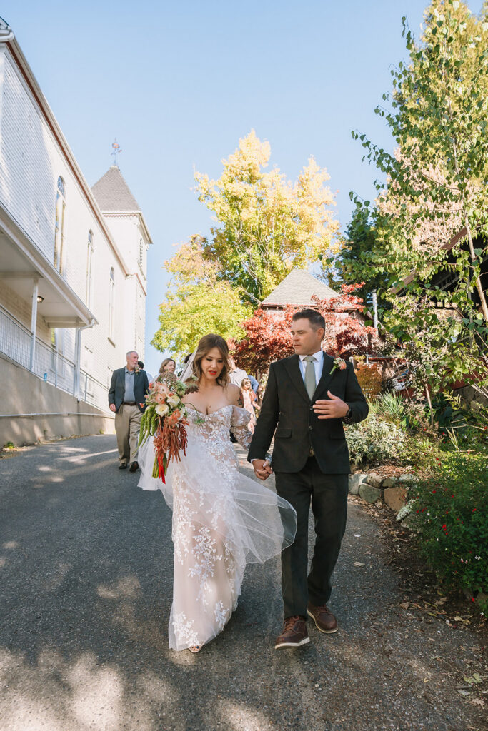 Bride and groom walking in Nevada City, California as they make their way to their wedding venue.