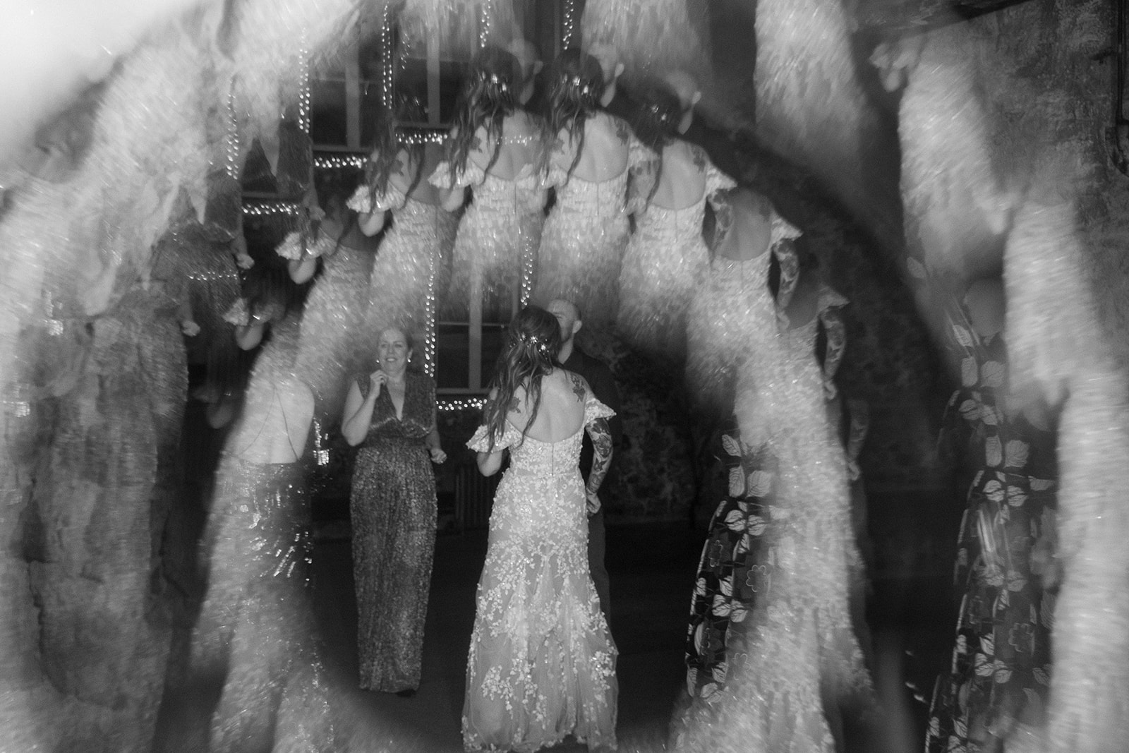 Creative black and white motion photo of bride dancing during reception at Miners Foundry wedding in Nevada City, California.