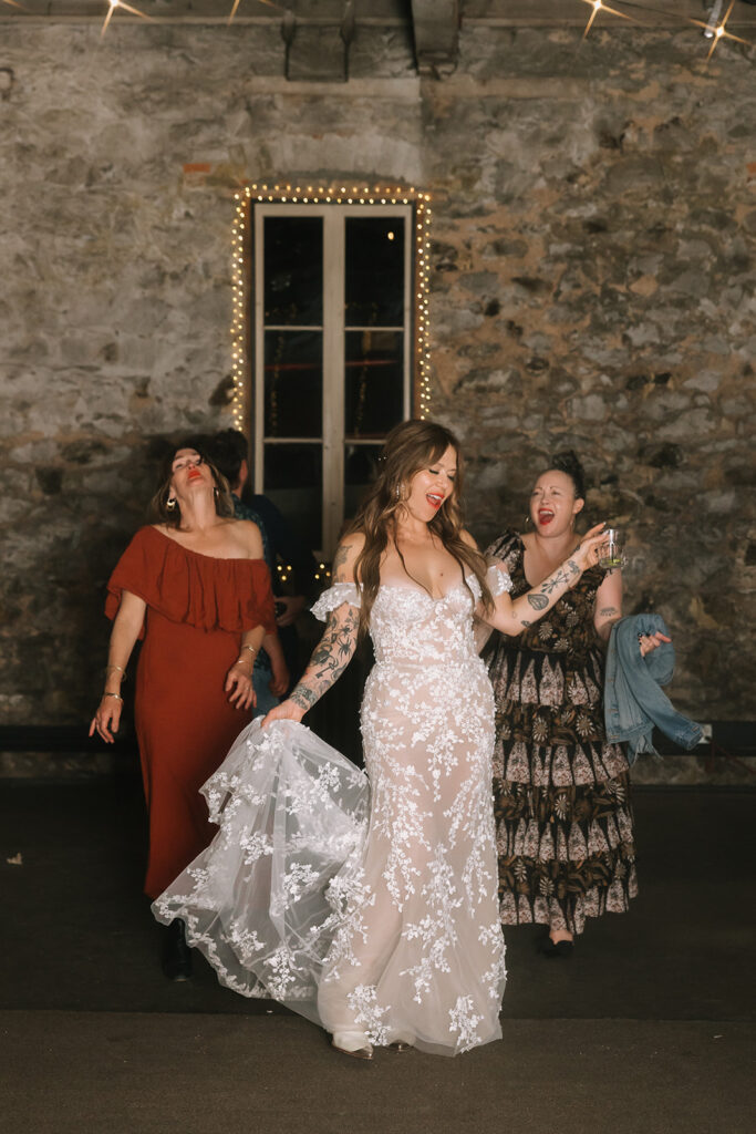 Bride dancing with friends during her Miners Foundry wedding reception in Nevada City, California. 