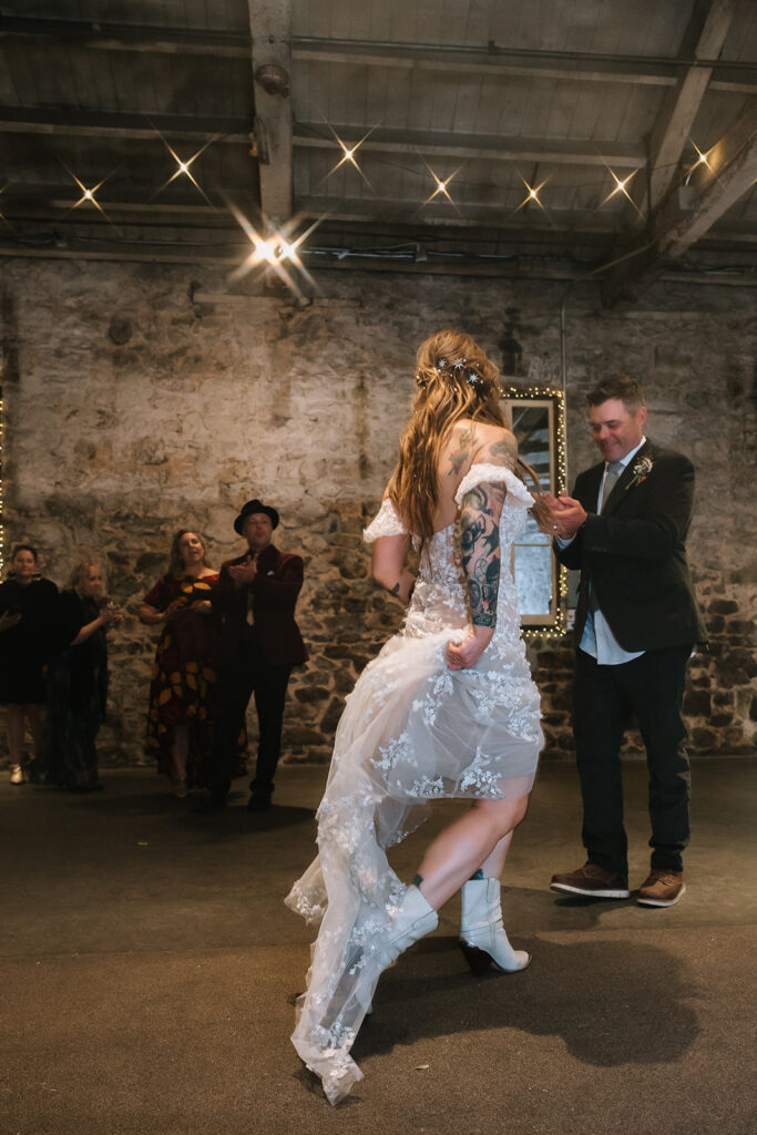 Bride dancing in boots at Miners Foundry wedding in Nevada City, California.