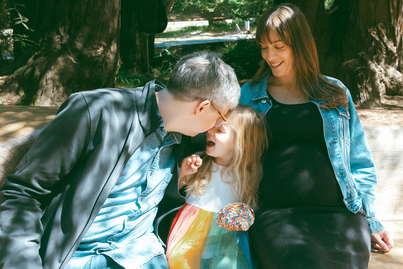Father kissing his daughter on the forehead. 