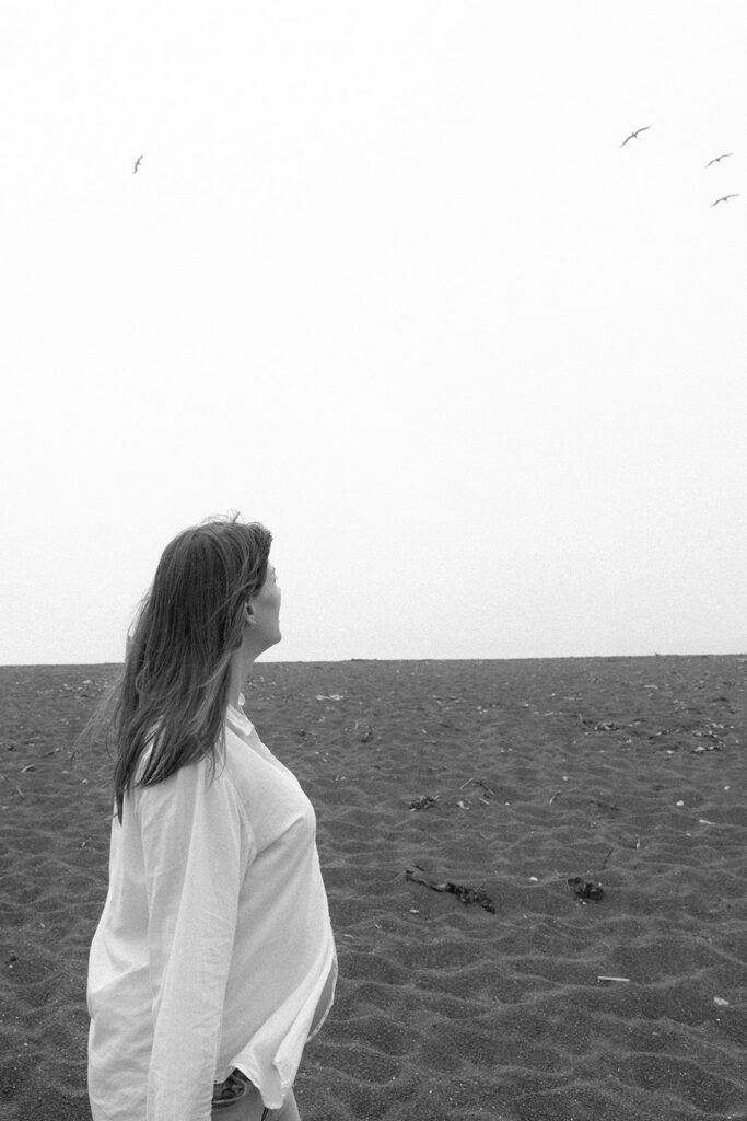 Pregnant woman watching seagulls in the sky at Rodeo Beach.