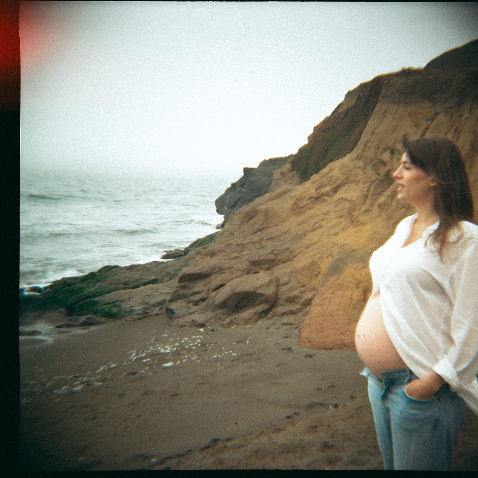 Pregnant mother with jeweled belly at Rodeo Beach in Marin Headlands photographed on film.