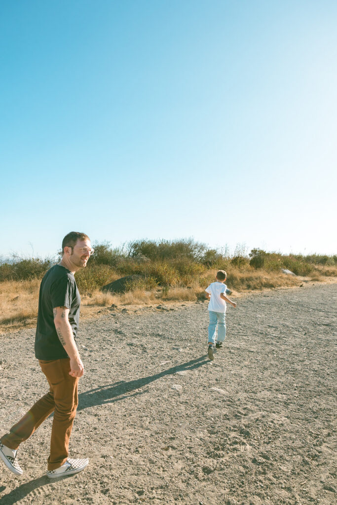 Father and son walking along the trails at Albany Bulb in California. 