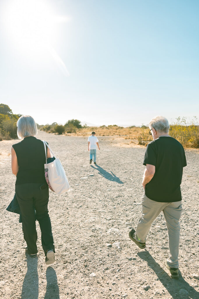 Grandparents and young boy walking at Albany Bulb during a three generation family session. 