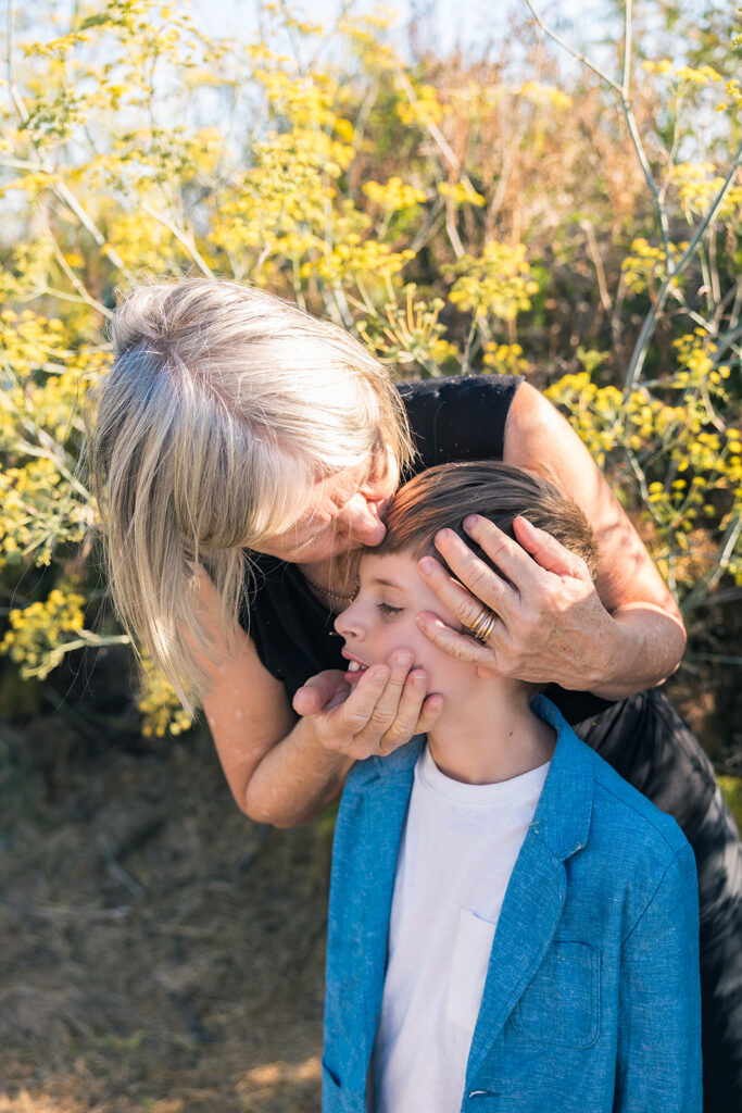 Grandmother kissing her grandsons head during their family photo session at Albany Bulb in the East Bay. 