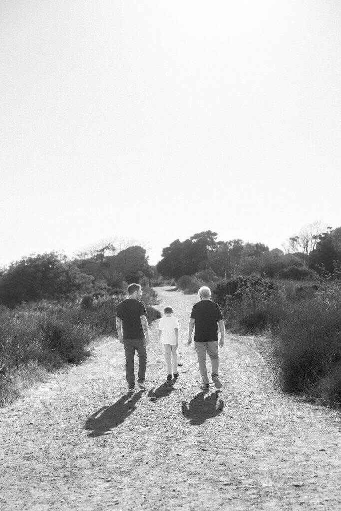  Black and white photo of three generations walking together at Albany Bulb. 