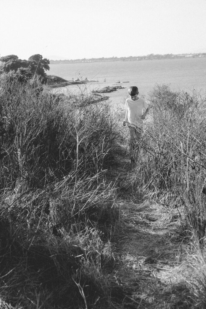 Black and white photo of a young boy walking the trail at Albany Bulb in the East Bay.