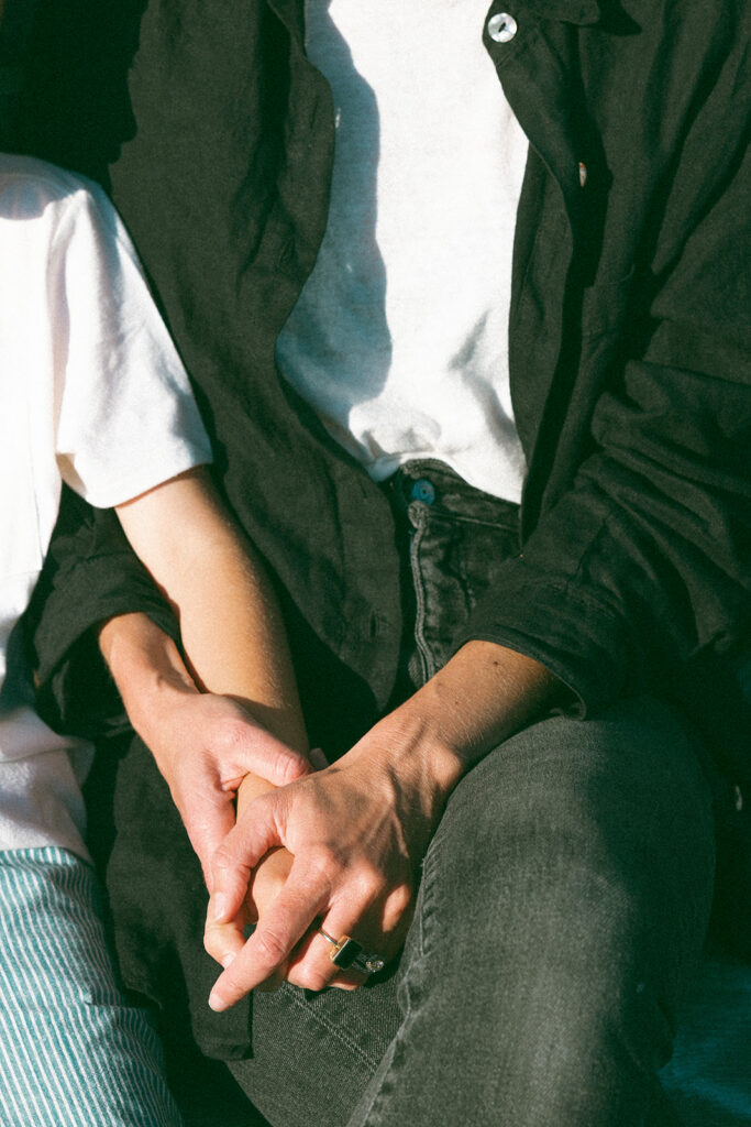 Close up photo of a mother holding her sons hand during their family photos. 