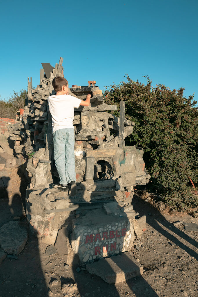 Child exploring a sculpture at Albany Bulb during an East Bay family photo session.