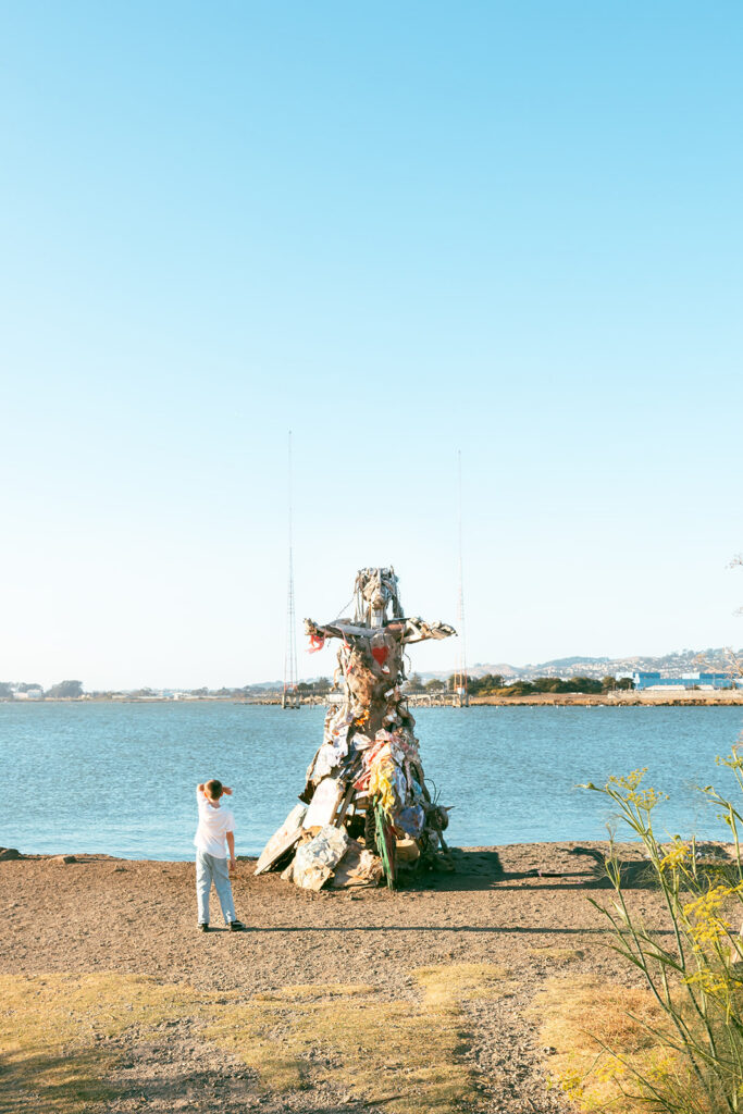 Young boy looking at art installation overlooking the San Francisco Bay at Albany Bulb.