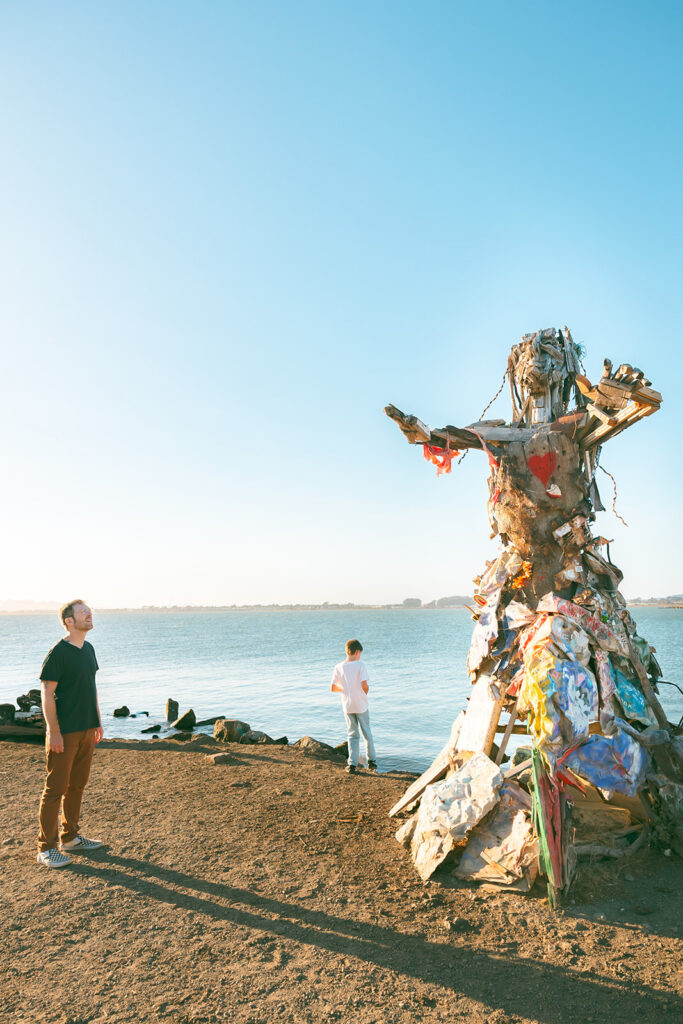 Father and son looking at art installation overlooking the San Francisco Bay at Albany Bulb.