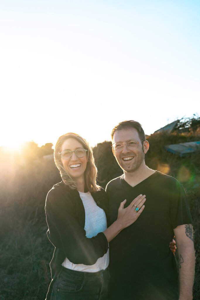 Man and woman posing along a trail at sunset in the East Bay.
