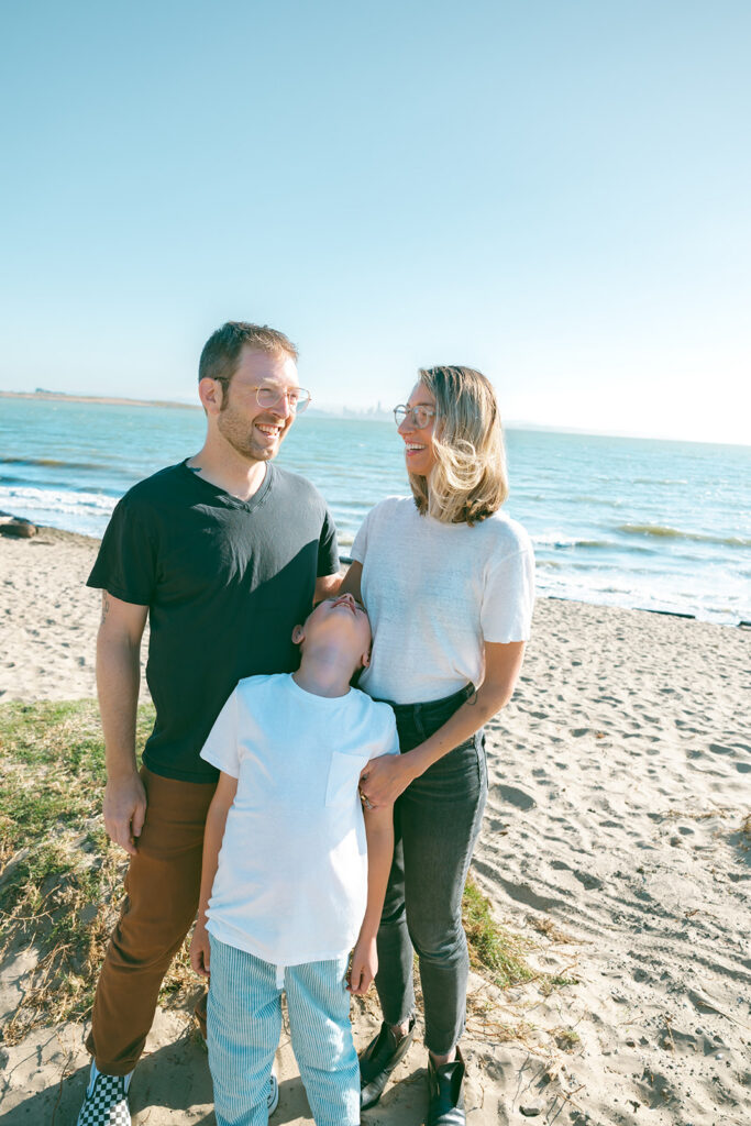 Candid photo of a family laughing together during their East Bay family photos at Albany Bulb. 