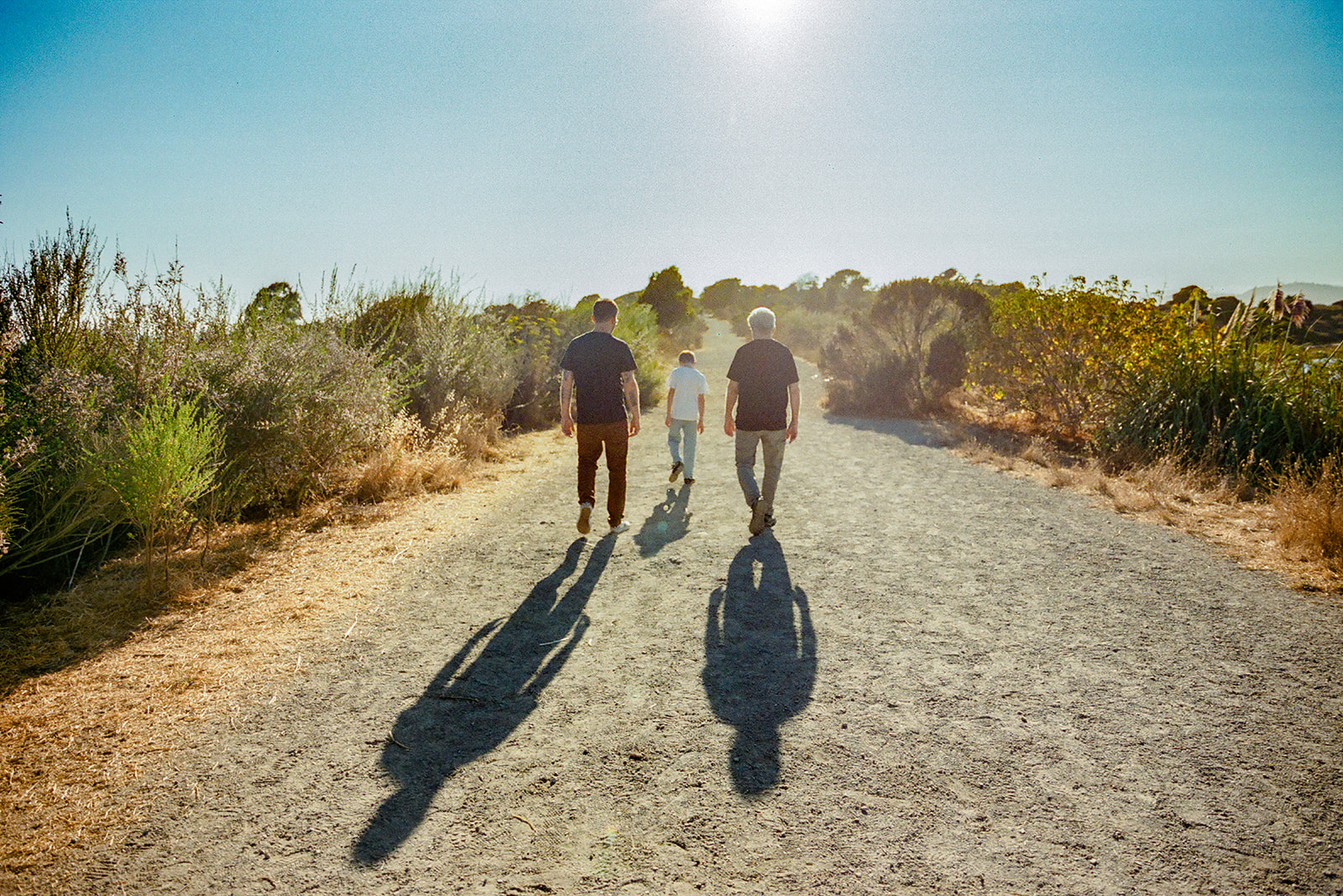 35mm film photo of three generations walking the trails at Albany Bulb together. 