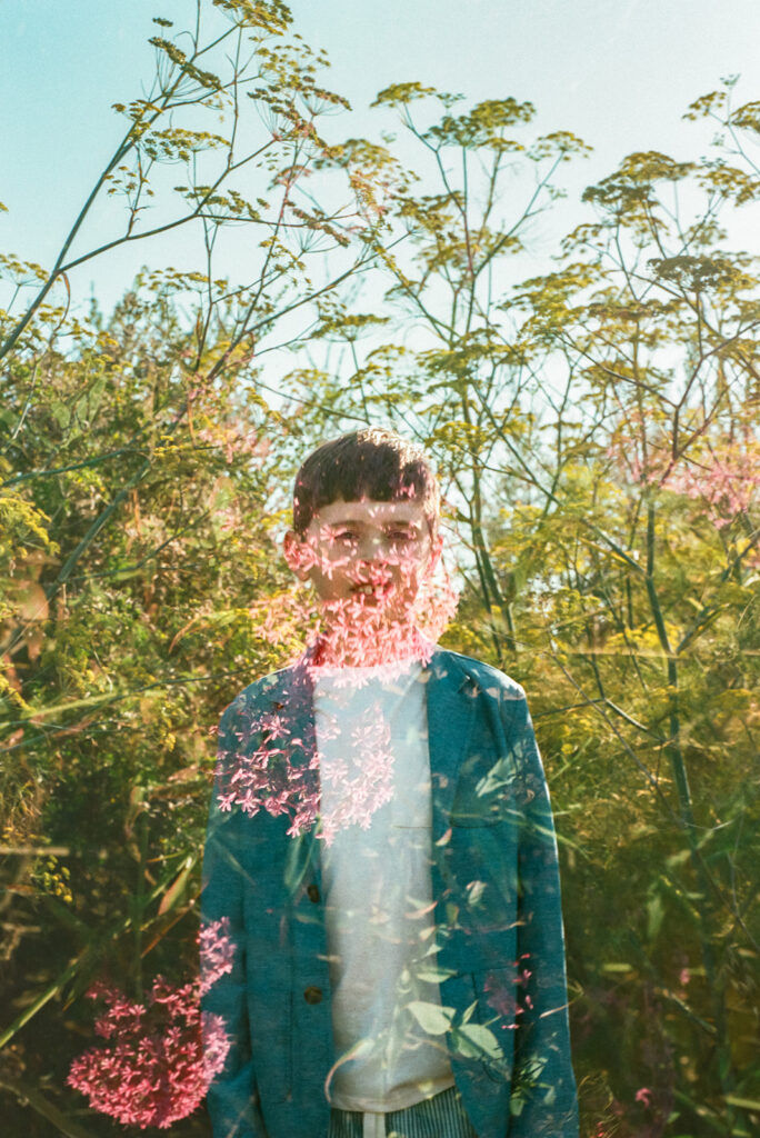 Double exposure film portrait of child surrounded by wildflowers during East Bay family photography session.