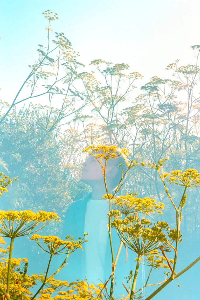 Double exposure film portrait of child surrounded by wildflowers during East Bay family photography session.