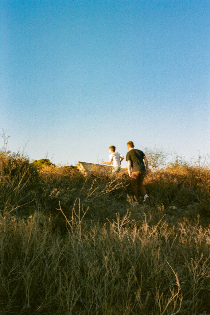 Film photograph of parents and child walking along hillside trail in the East Bay.