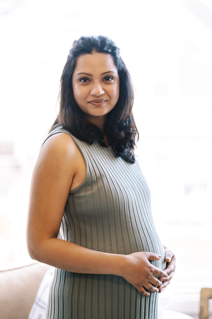 Pregnant woman posing inside her home for her San Francisco maternity photos at home.