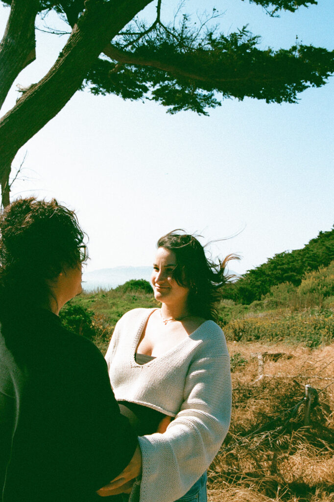 Woman smiling at her partner at Lands End on film.