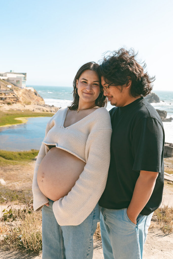 Couple posing at Lands End for their San Francisco couples maternity photos.