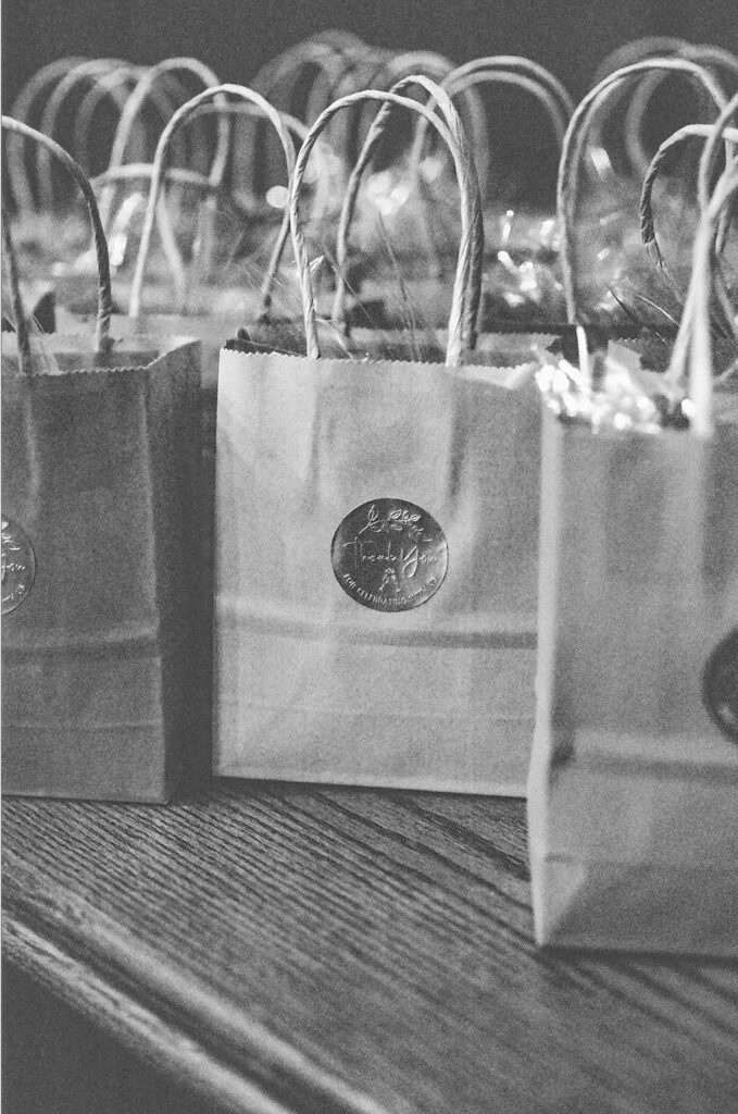 Black and white film photo of guest gift bags.