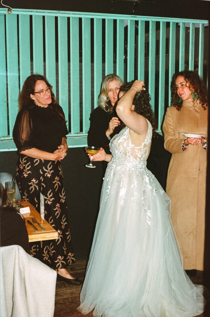 Film photo of the bride mingling with family and friends at her SF wedding reception at Fiorella.
