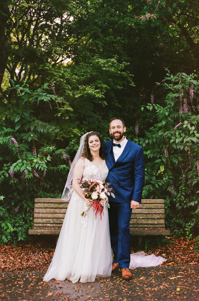 Bride and groom posing on film at San Francisco Botanical Garden.