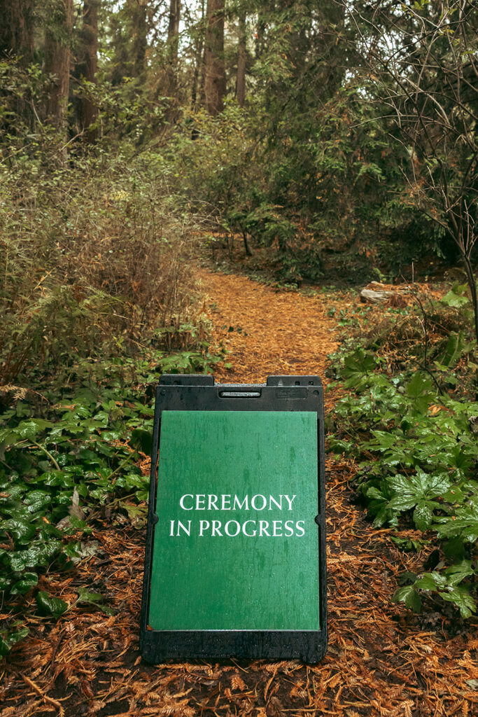 Ceremony in progress sign for a San Francisco Botanical Garden wedding ceremony in Redwood Grove.