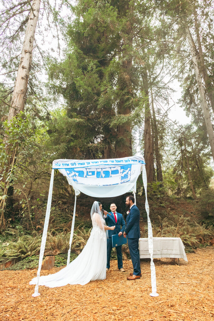 Bride giving a speech during their outdoor San Francisco Botanical Garden wedding ceremony in Redwood Grove.
