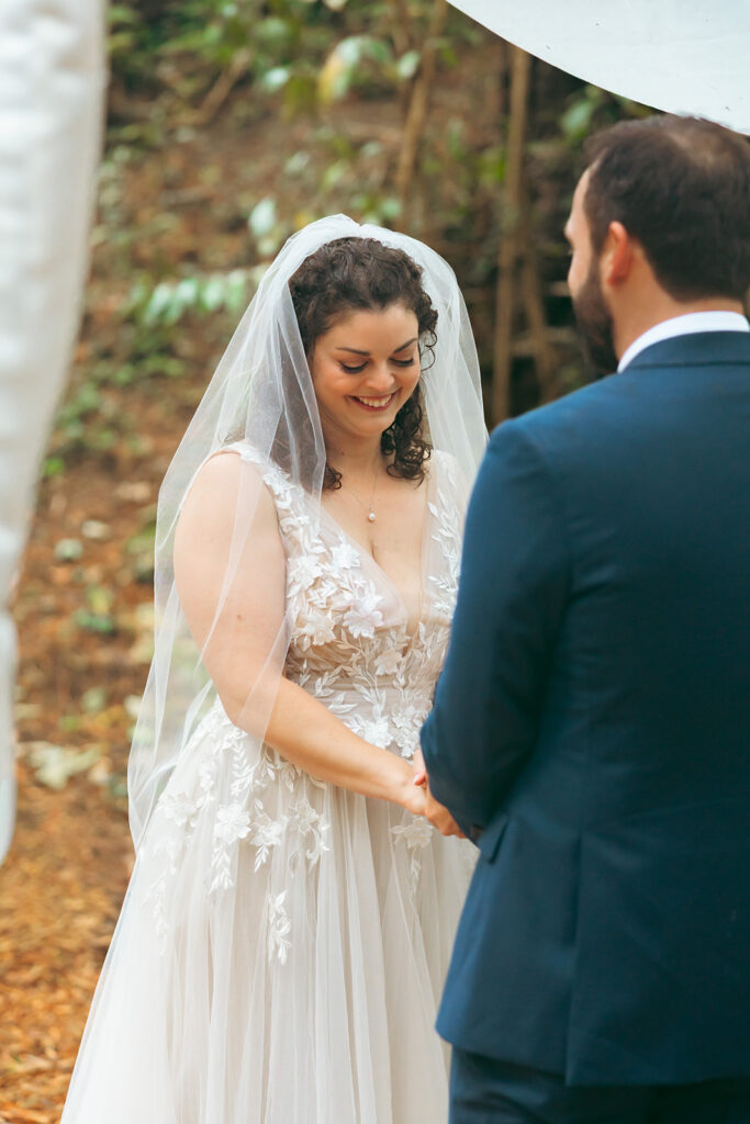 Bride smiling during her San Francisco Botanical Garden wedding ceremony in Redwood Grove.