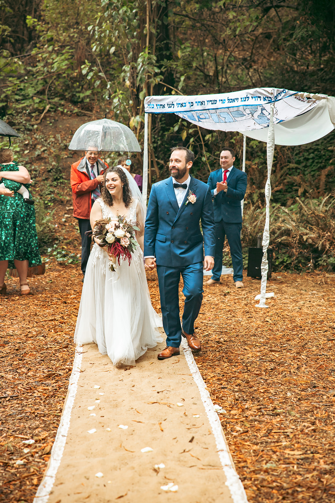 Bride and groom walking back down the aisle as husband and wife after their San Francisco Botanical Garden wedding ceremony in Redwood Grove.