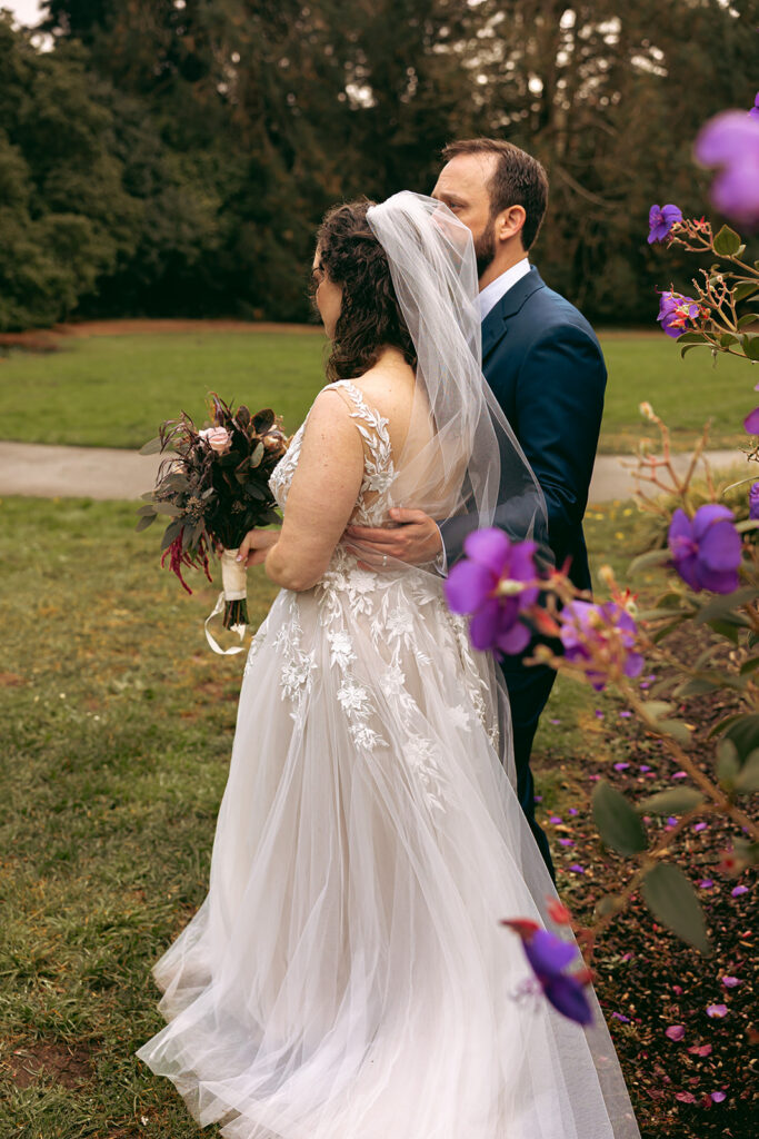 Bride and groom posing for their San Francisco Botanical Garden wedding photos.