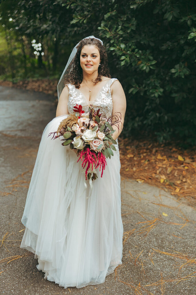 Bride posing for a photo with her bouquet for her San Francisco Botanical Garden wedding.