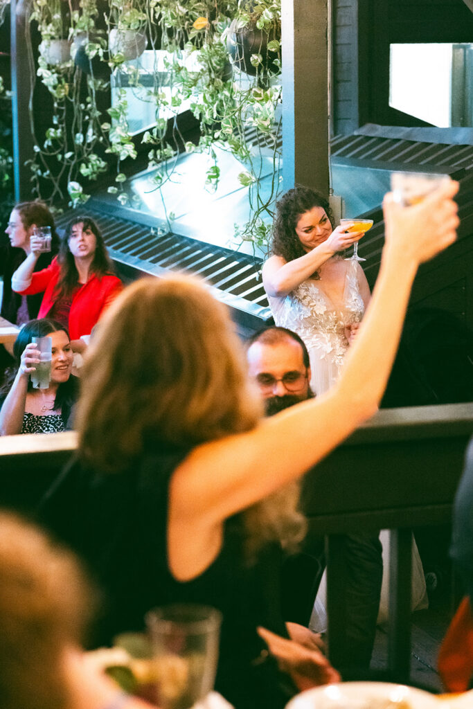 Guests toasting during a speech.