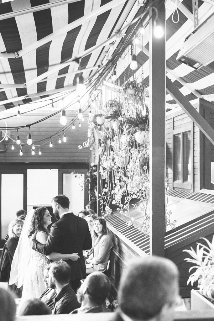 Bride and groom hugging one another.