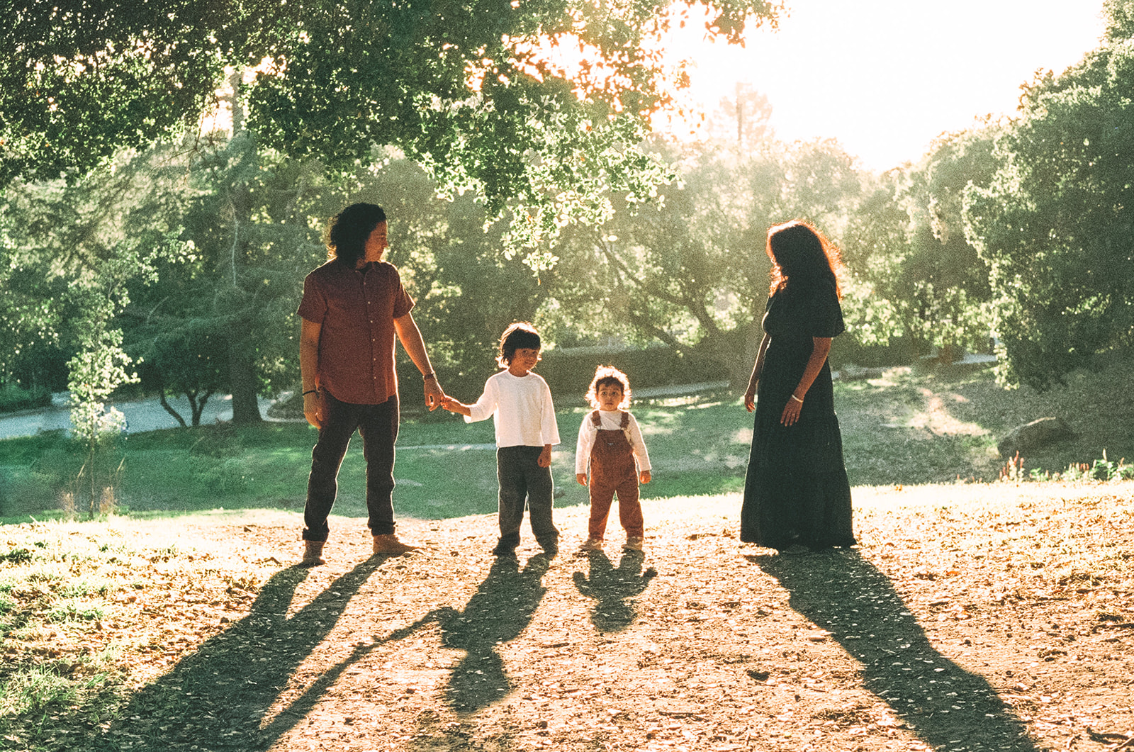 35mm film photo of a family of four standing in golden fall light during East Bay family photos at John Hinkel Park.