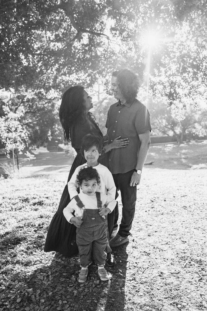 Black and white photo of a family of four posing during golden hour at John Hinkel Park in the East Bay of California.